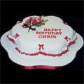 A modern petal-shaped rich fruit cake with burgundy and white sugar crafted flowers, frills and bows.