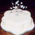 A rich chocolate cake with quilted sides and a sugar-crafted pale blue star-burst.
