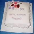 A rich petal-shape 70th birthday fruit cake with a simple design.