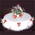 A cake prepared for a Ruby Wedding celebration, with red and white sugar crafted flowers, red bows and white frills.